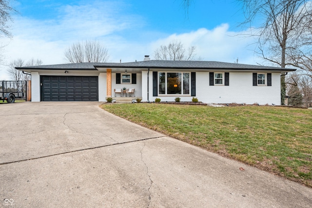 ranch-style house with a garage and a front lawn