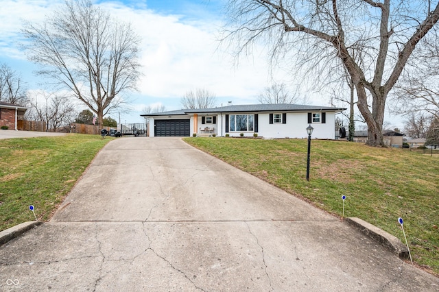 ranch-style home featuring a garage and a front yard