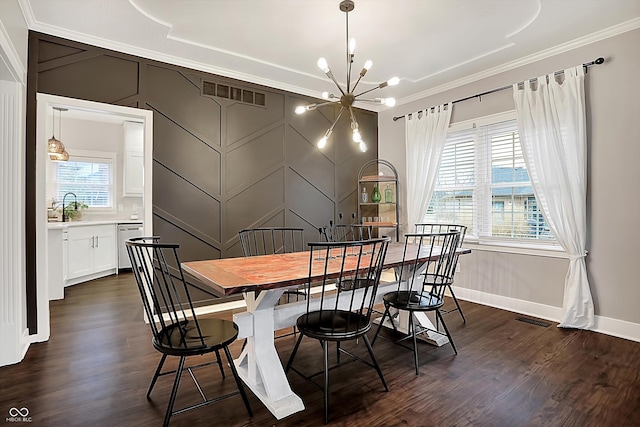 dining space featuring an inviting chandelier, sink, crown molding, and dark hardwood / wood-style flooring