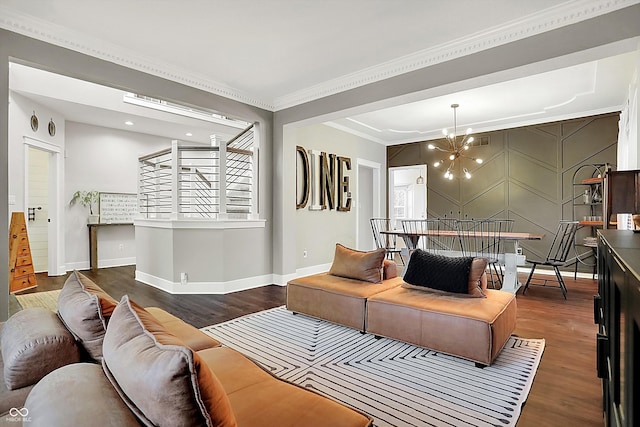 living room featuring crown molding, dark hardwood / wood-style flooring, and an inviting chandelier