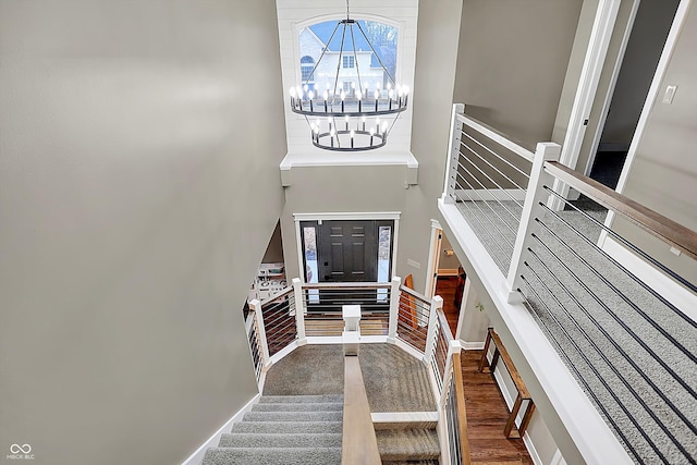 entrance foyer featuring a towering ceiling and an inviting chandelier