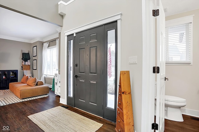 entryway featuring crown molding and dark wood-type flooring