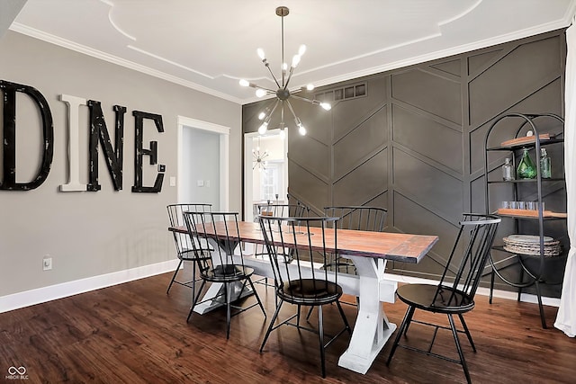 dining room with an inviting chandelier, ornamental molding, and dark wood-type flooring