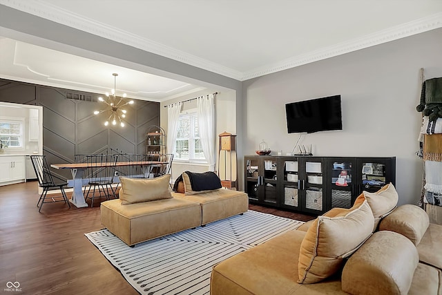 living room with an inviting chandelier, crown molding, and dark hardwood / wood-style flooring