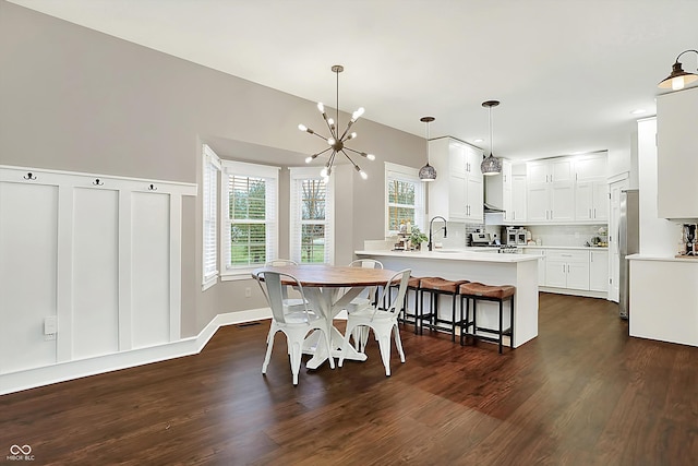 dining area with an inviting chandelier and dark hardwood / wood-style floors