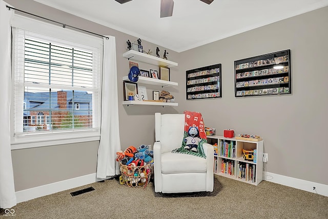 recreation room featuring ornamental molding, carpet floors, and ceiling fan