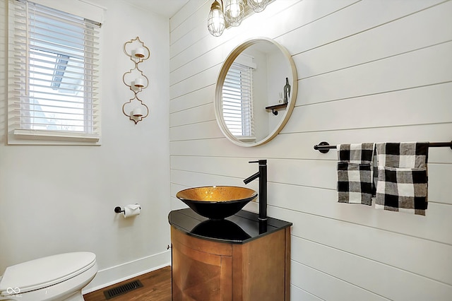 bathroom featuring sink, hardwood / wood-style floors, and toilet