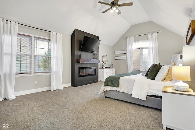 bedroom with vaulted ceiling, light colored carpet, ceiling fan, and a fireplace