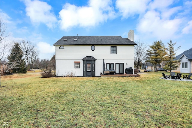 rear view of house featuring a yard and a patio area