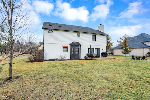 rear view of house featuring a yard