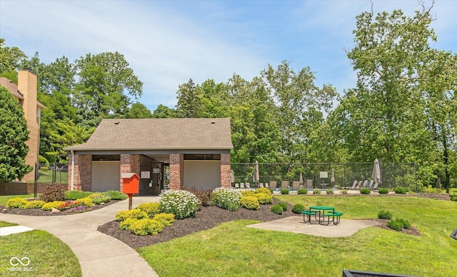 surrounding community with a yard and a patio area