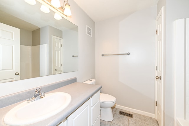 bathroom featuring vanity, toilet, tile patterned flooring, and a shower