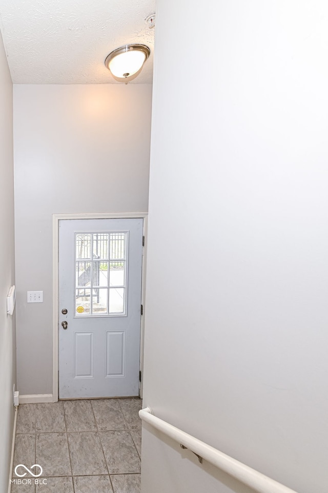 entryway with light tile patterned flooring