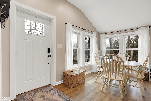 entryway with vaulted ceiling and hardwood / wood-style floors