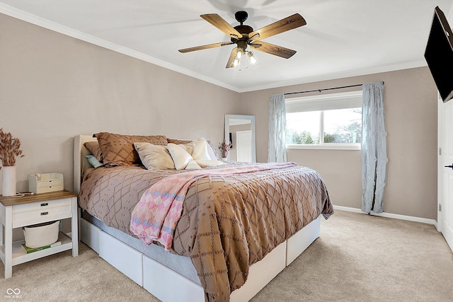 carpeted bedroom featuring ornamental molding and ceiling fan