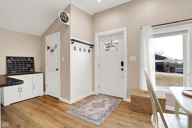 foyer with lofted ceiling and light wood-type flooring