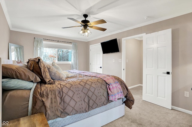 carpeted bedroom featuring ornamental molding and ceiling fan