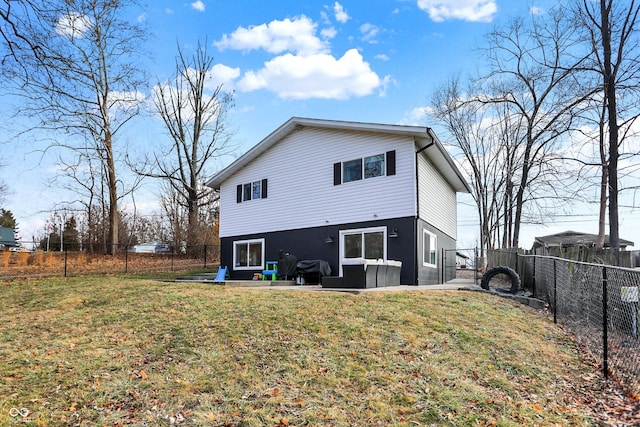 rear view of property with a yard and a patio area