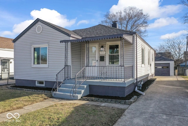 view of front facade with a garage, an outdoor structure, a porch, and a front lawn