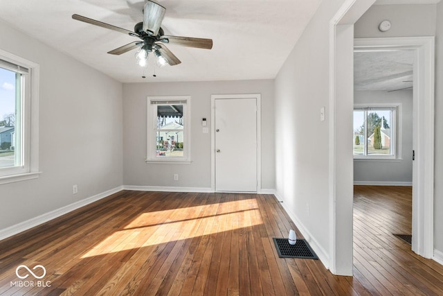 foyer with dark wood-type flooring, ceiling fan, and plenty of natural light