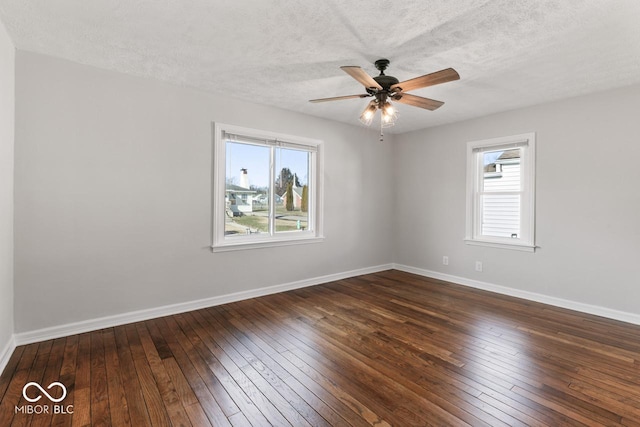 unfurnished room featuring ceiling fan, dark wood-type flooring, and a textured ceiling