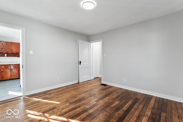 empty room with wood-type flooring