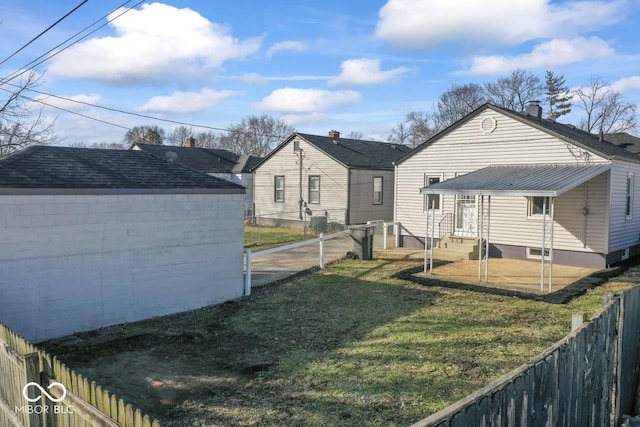 back of house with a lawn