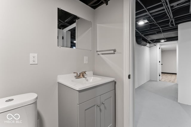 bathroom featuring vanity, toilet, and concrete floors