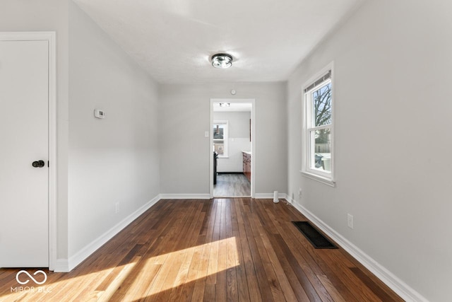 hallway with dark hardwood / wood-style flooring