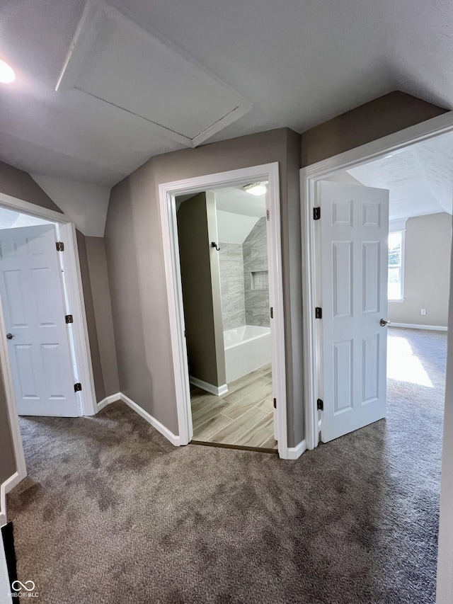 interior space with lofted ceiling and carpet