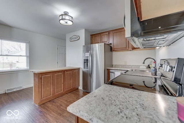 kitchen with stainless steel fridge with ice dispenser, dark hardwood / wood-style floors, sink, and a kitchen island