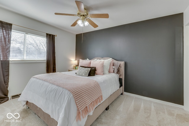 bedroom featuring light colored carpet and ceiling fan