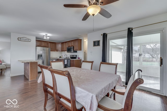 dining room with dark hardwood / wood-style floors and ceiling fan