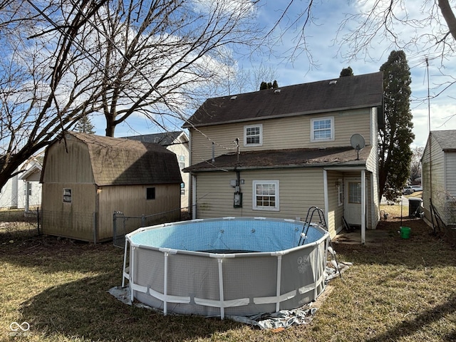 back of property featuring a yard and a storage unit