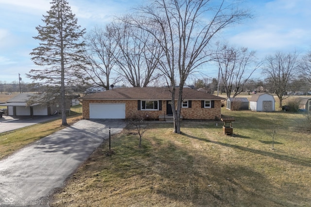 ranch-style house with a garage, a front lawn, and a storage unit