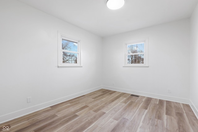 unfurnished room with light hardwood / wood-style flooring and a wealth of natural light