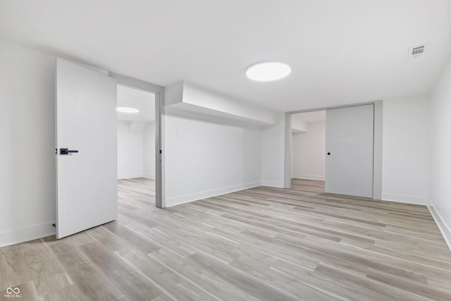 basement featuring light hardwood / wood-style floors