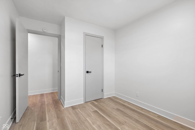 unfurnished bedroom featuring light wood-type flooring