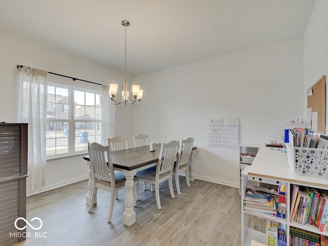 dining room with an inviting chandelier and light wood-type flooring