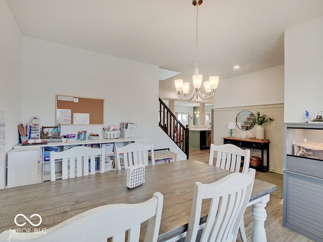 dining space with an inviting chandelier and light hardwood / wood-style floors