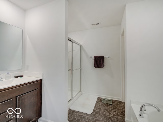 bathroom with vanity and independent shower and bath