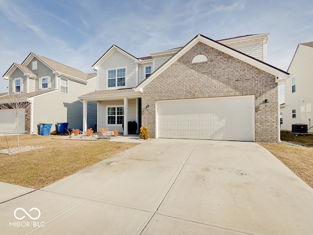 view of front of home featuring a garage, a front yard, and central air condition unit