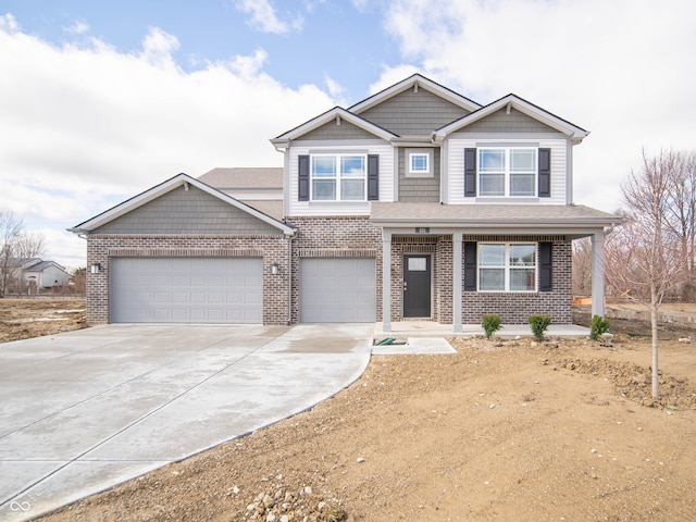 craftsman-style home with concrete driveway and brick siding