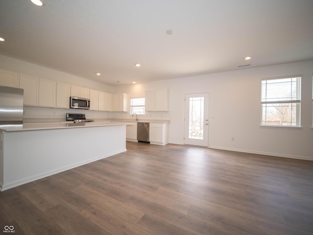 kitchen featuring white cabinets, dark wood-style floors, appliances with stainless steel finishes, light countertops, and recessed lighting