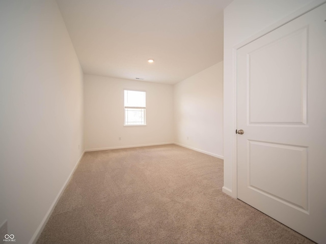 unfurnished room with baseboards, recessed lighting, and light colored carpet