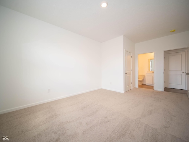 unfurnished bedroom with recessed lighting, carpet flooring, connected bathroom, and baseboards