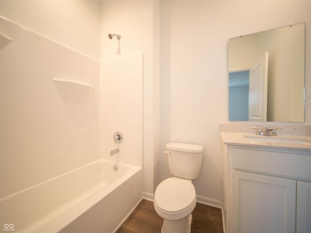 full bathroom with bathing tub / shower combination, toilet, vanity, wood finished floors, and baseboards