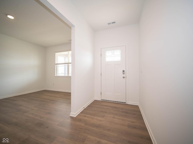 foyer entrance featuring visible vents, baseboards, dark wood-type flooring, and recessed lighting