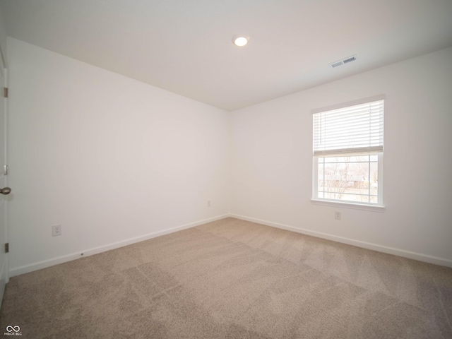 carpeted spare room featuring recessed lighting, visible vents, and baseboards