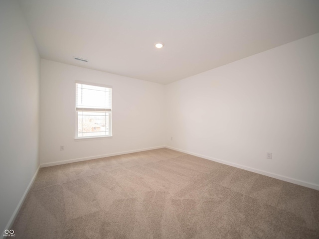 carpeted empty room with recessed lighting, visible vents, and baseboards